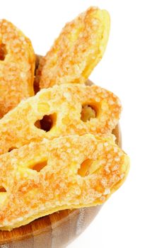 Puff Pastry Cookie Sprinkled with Sugar Crystals in Wooden Bowl closeup on white background