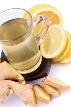 Arrangement of Glass Cup of Tea, Ginger and Lemon Slices closeup on white background