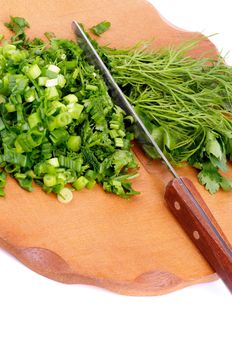 Arrangement of Chopped Chives, Parsley and Dill with Knife on Wooden Cutting Board closeup