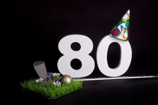 A golf club and golf ball on an artificial peace of grass to be used as a birthday card