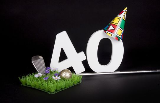 A golf club and golf ball on an artificial peace of grass to be used as a birthday card