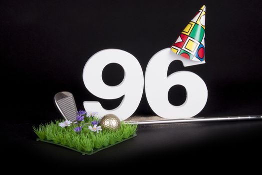 A golf club and golf ball on an artificial peace of grass to be used as a birthday card