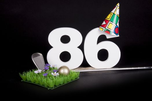 A golf club and golf ball on an artificial peace of grass to be used as a birthday card