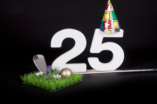 A golf club and golf ball on an artificial peace of grass to be used as a birthday card