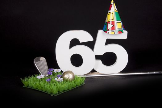 A golf club and golf ball on an artificial peace of grass to be used as a birthday card