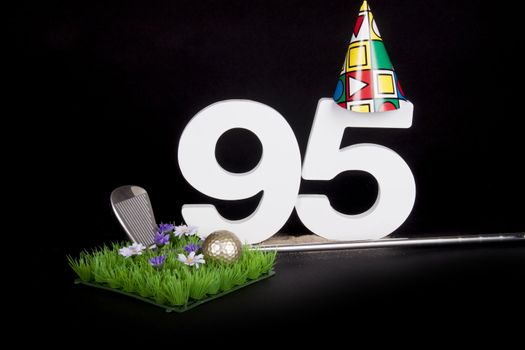 A golf club and golf ball on an artificial peace of grass to be used as a birthday card