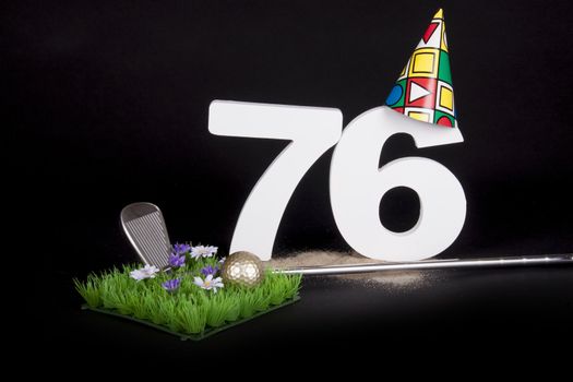 A golf club and golf ball on an artificial peace of grass to be used as a birthday card