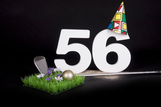 A golf club and golf ball on an artificial peace of grass to be used as a birthday card