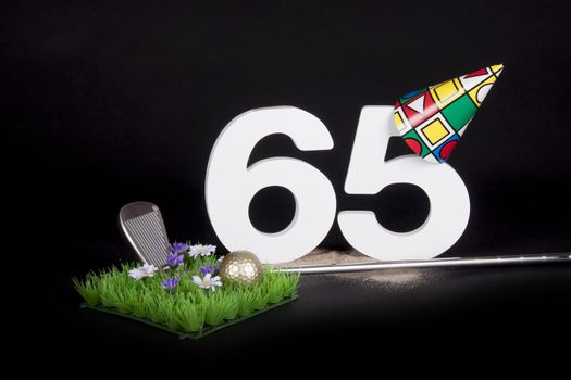 A golf club and golf ball on an artificial peace of grass to be used as a birthday card