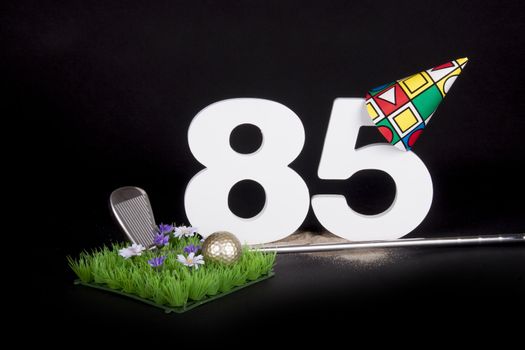 A golf club and golf ball on an artificial peace of grass to be used as a birthday card