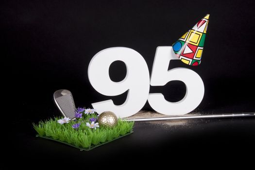 A golf club and golf ball on an artificial peace of grass to be used as a birthday card