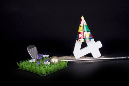 A golf club and golf ball on an artificial peace of grass to be used as a birthday card