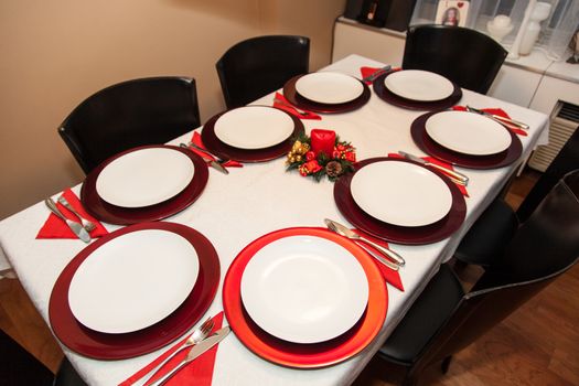 Simple decorated Christmas dinner table for eight people.