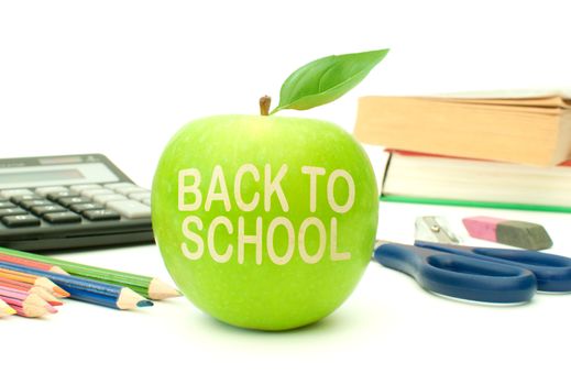 Back to school carved into an apple surrounded by books and stationery