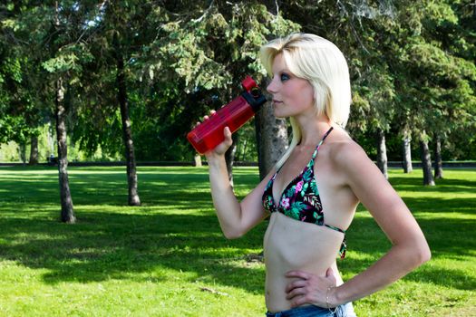 Fit young woman with water bottle