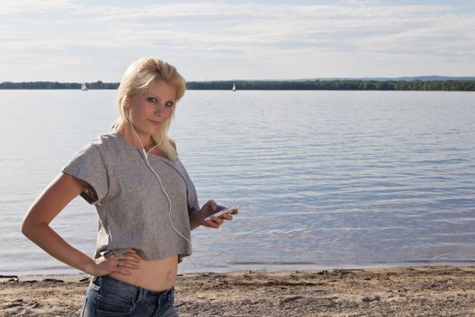 Young woman on the beach listening to music