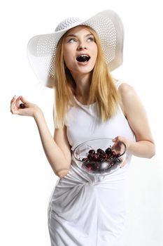 Young pretty woman with cherry on the white background