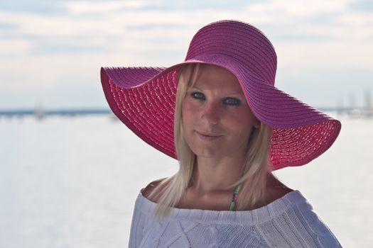 Young woman with a pink sun hat