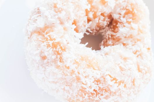 Piece of vanilla coconut donut up close, stock photo