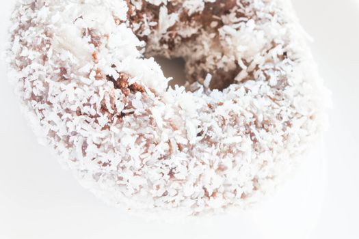 Piece of chocolate coconut donut up close, stock photo