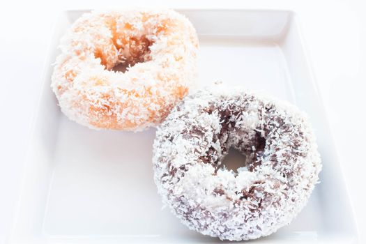 Chocolate and vanilla donuts with coconut cover, stock photo