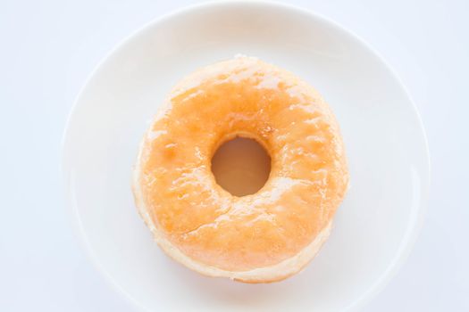 Classic donut serving on white dish, stock photo