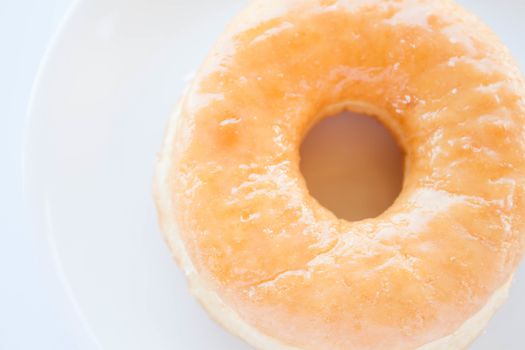 Close up classic donut serving on white dish, stock photo