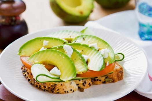 Avocado with Feta ,Cucumber and Tomato on Pumpkin and sesame bread sandwich