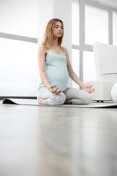 Pregnant woman doing yoga exercise