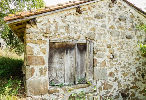 Vintage old wooden gate in traditional stone house