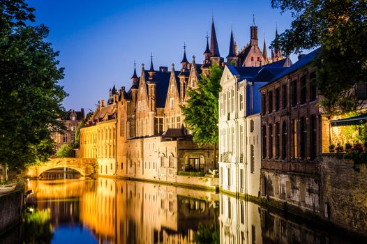 Water canal and medieval houses at night in Bruges, Belgium