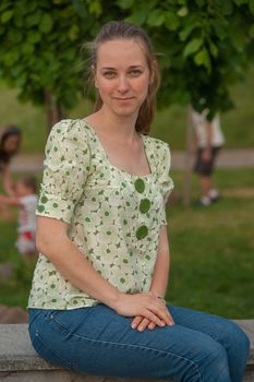 Beautiful young woman in park in summer.