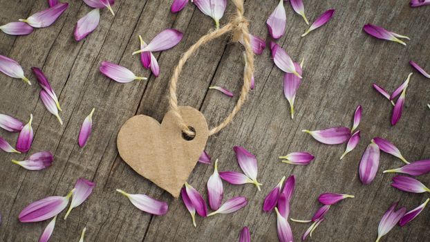 A paper heart with string on wooden background