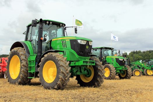 SALO, FINLAND - AUGUST 10: John Deere agricultural tractors 6170M and 6190R displayed at the annual Puontin Peltopaivat Agricultural Show in Salo, Finland on August 10, 2013.