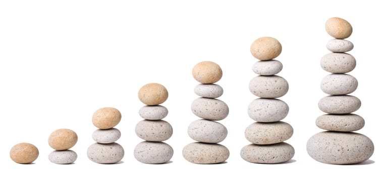 Seven Stacks of Stones on a white Background - a nice Zen-like Background