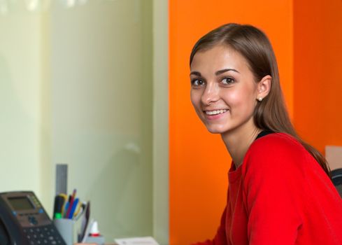 Beautiful girl in bright clothes at your desk