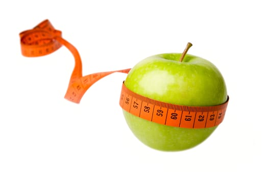 Green apple and measuring tape isolated on a white background