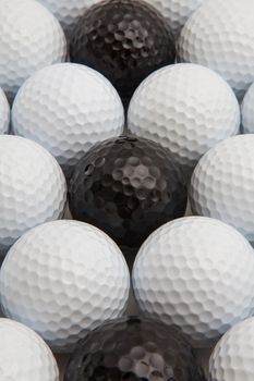 Different golf balls and wooden tees