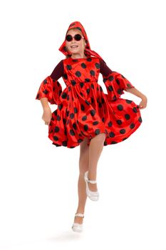 Teen girl dancing in a red polka-dot dress with sunglasses. Isolate on white.