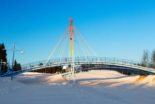 Bridge on the background of a winter landscape on a sunny day