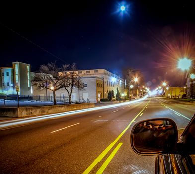 standing in car on side of the road at night in the city