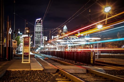 Charlotte City Skyline night scene with light rail system lynx train