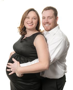 Man and pregnant wife awaiting baby, studio portrait