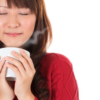 Beautiful mixed Asian young woman enjoying a cup of coffee, with coffee smoke and copy space on right, isolated on white background.