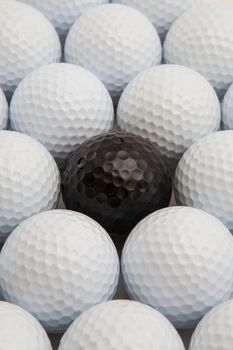 Different white and black golf balls