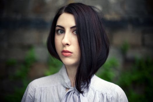 Portrait of a Strange Girl with Big Eyes. Close-up. Serious look