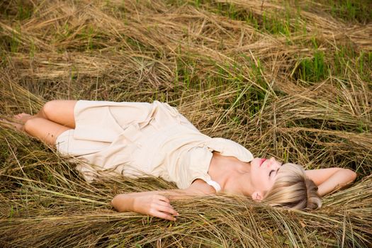 Beautiful girl enjoying the nature on a fresh hay