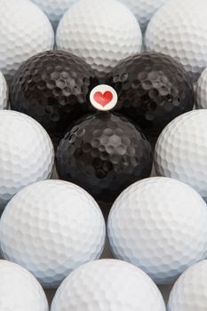 Different golf balls and romantic wooden tee