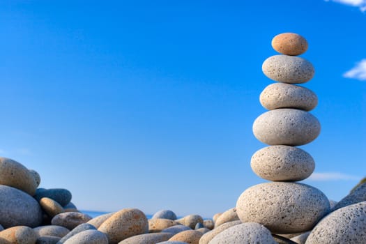 Round stones on a background of blue sky