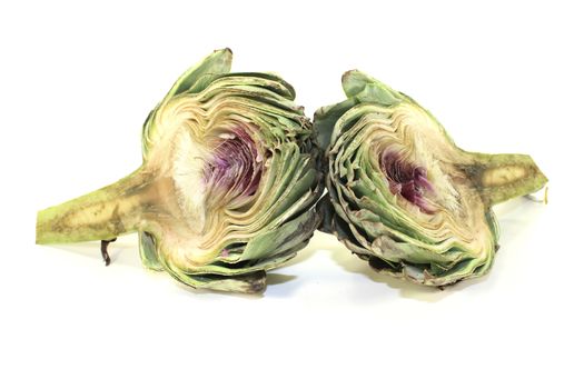 one sliced artichoke on a light background